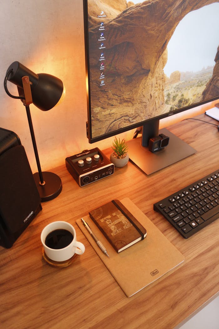 Stylish home office desk setup featuring coffee, tech gadgets, and decor items for productivity.