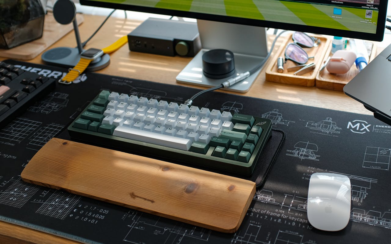 Stylish home office setup featuring a mechanical keyboard and tech accessories on a desktop.